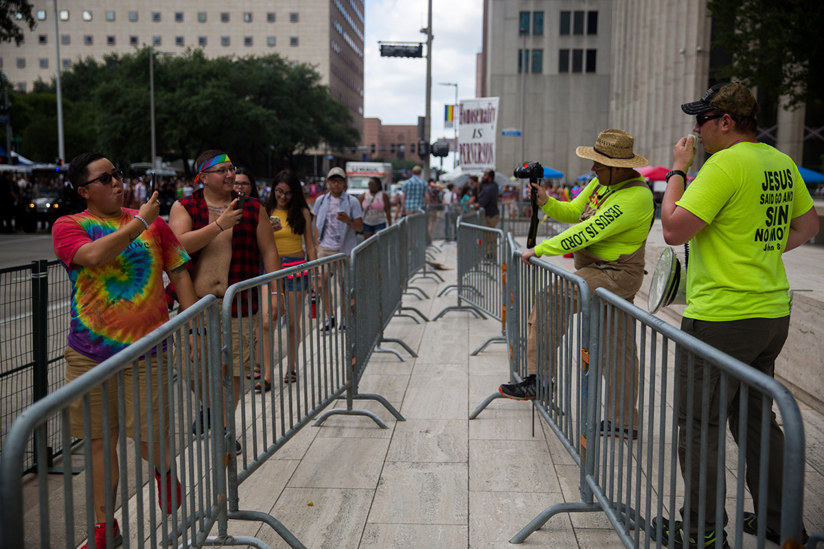 Participants and protesters photograph each other at the Houston Pride Parade in June. (Shelby Knowles/News21)
