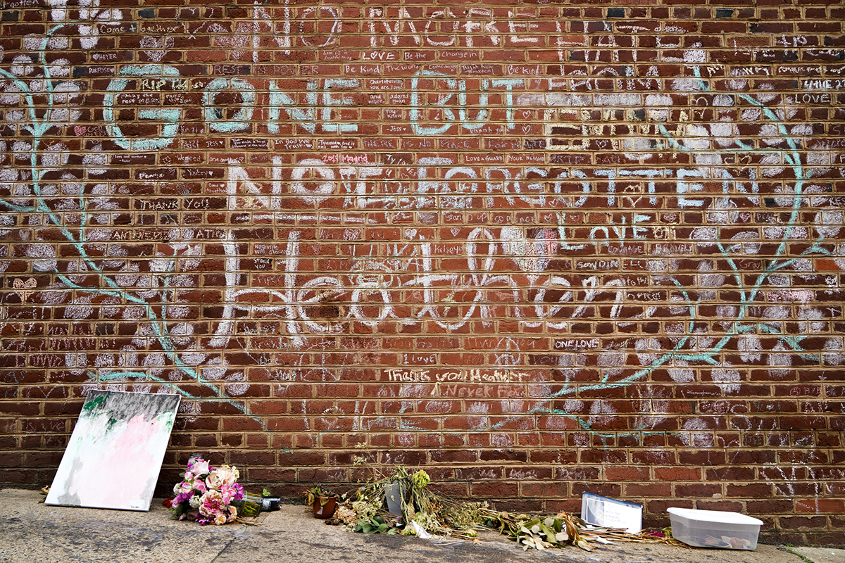 Flowers and gifts sit under the memorial wall for Heather Heyer in Charlottesville, Virginia, just off the Honorary Heather Heyer Way. The city renamed the stretch of Fourth Street for Heyer, 32, who was killed by a motorist. (Kianna Gardner/News21)