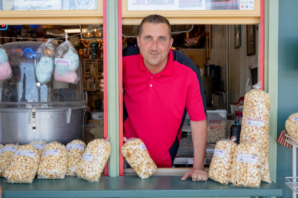 "I come from an ethnic family. My daughter is half African-American so I am very sensitive to the topic of hate," Paul Coombes said. "I think all races have a lot of work to do." Coombes handed out free samples of kettle corn to tourists outside Breck and Dave’s Kettle Corn Depot on Virginia City's South C Street. (Lenny Martinez/News21)