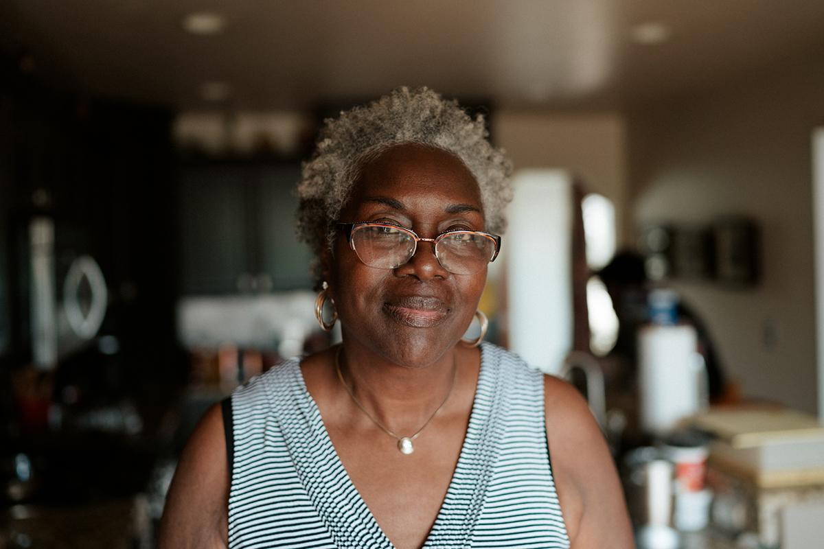 Debra Davis stands in the kitchen of her Clio, Michigan, home, where she has lived for 15 years. When her family's vehicle was vandalized in their front yard, she used the moment to teach her grandchildren about racial intolerance today. "They just got an opportunity to see firsthand something that they usually see from a distance," Davis said. (Megan Ross / News21)