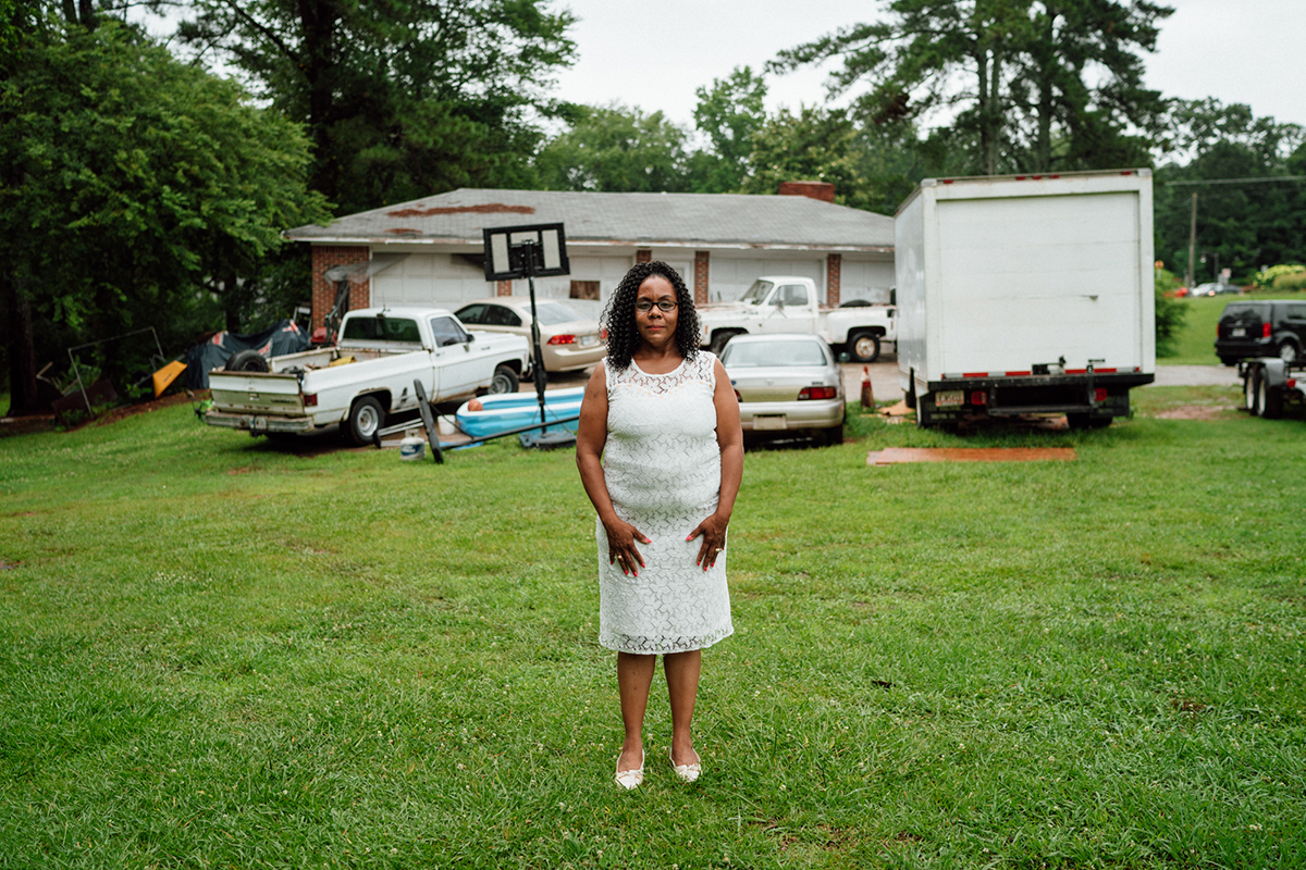 Melissa Alford stands in her yard, where members of a Confederate pride group terrorized a family birthday party she hosted in 2015. (Megan Ross / News21)