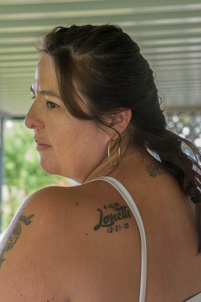 Nicole Walksalong has a tattoo on her back with her mother's name and the date of her birth and death. She said prosecutors should have pushed harder for a hate crime charge in the death of her mother, Lonette Keehner. (Tilly Marlatt/ News21)