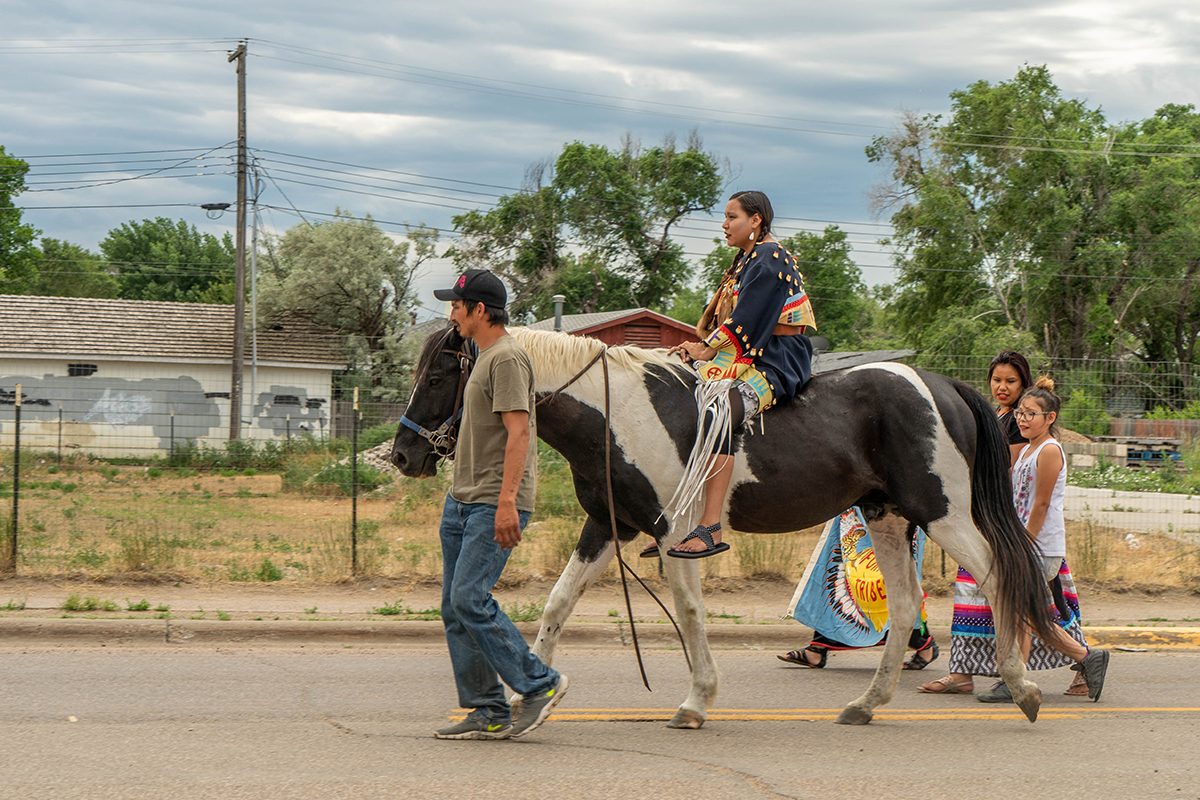 Thomas Holmes leads his horse, Lakota, through the streets of Poplar during the June 26 Keystone XL protest. (Tilly Marlatt/ News21)