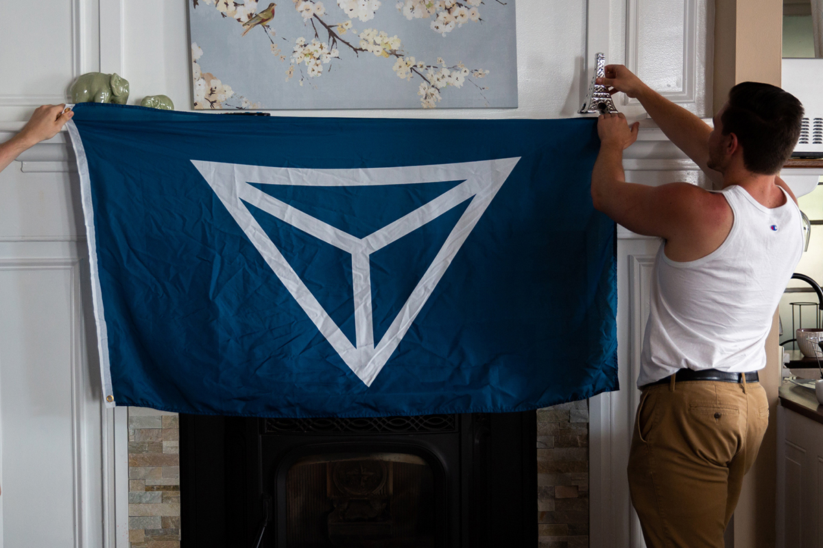 Members of Identity Evropa, many of whom prefer not to be identified, hang their group's flag. The organization's goal is to enable a white supermajority in America by bringing their political ideas mainstream and expanding their political and social influence. (Shelby Knowles/News21)