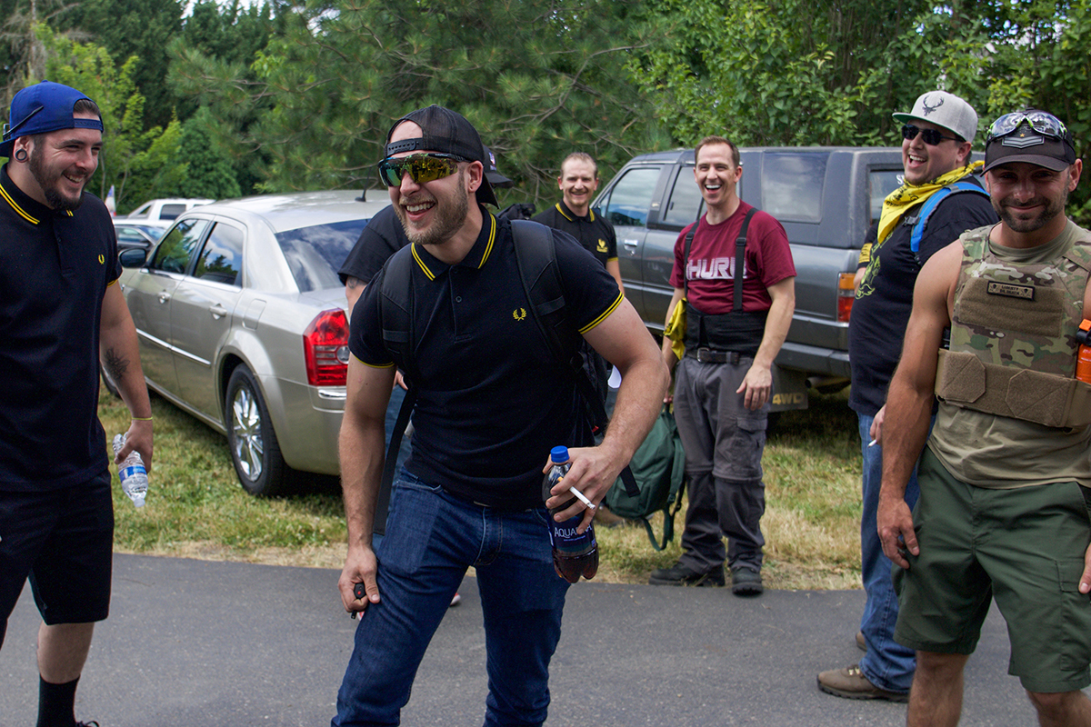 Proud Boy Aaron Williamson tases himself in the thigh at the Proud Boys pre-rally drinking session. The Proud Boys were searched and disarmed by police before the rally began. (Rosanna Cooney/News21)