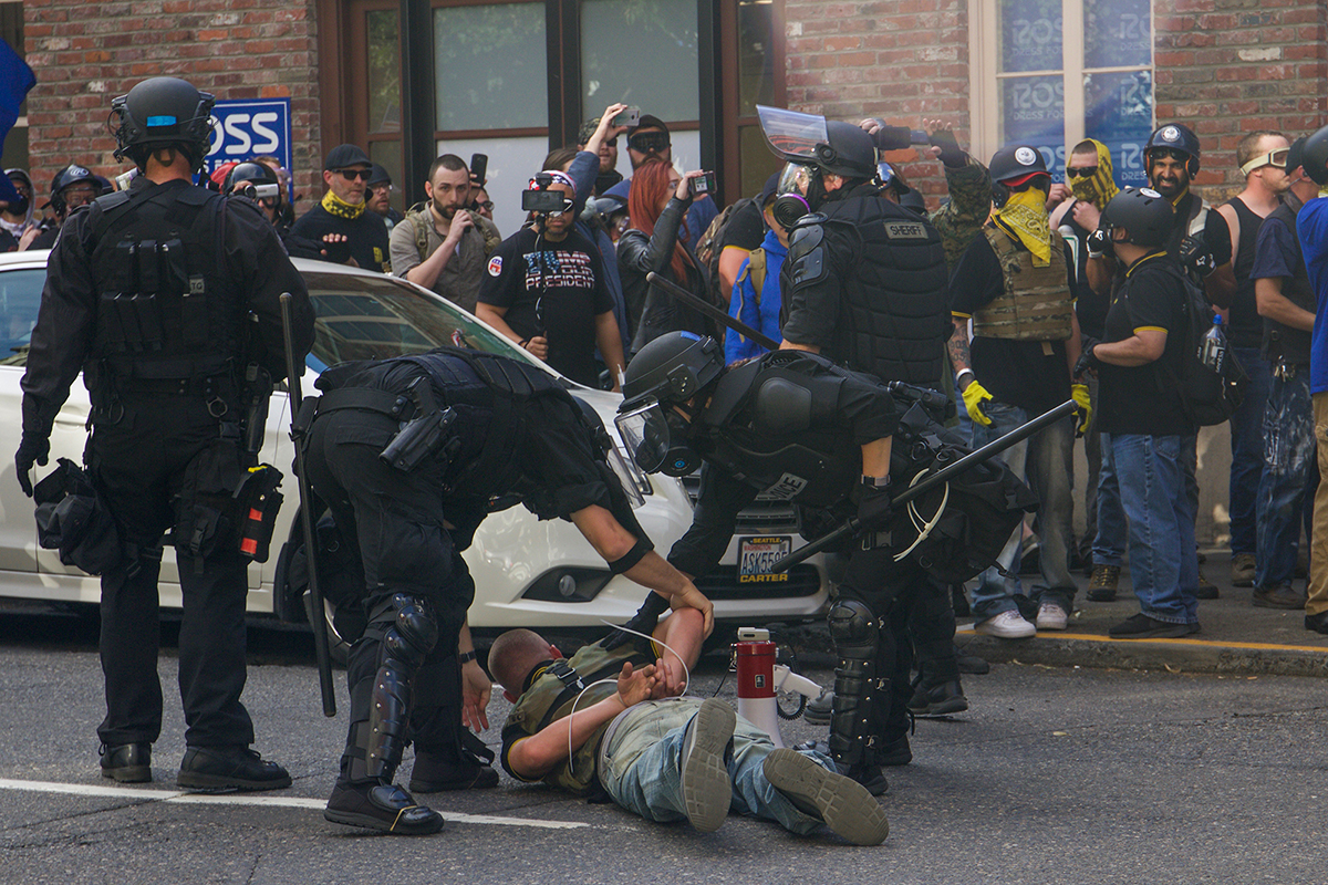 A member of the Proud Boys is restrained with cable ties after being involved with the antifa fight in downtown Portland. (Rosanna Cooney/News21)