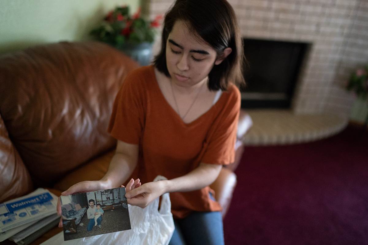 Blanca Reyes, 20, holds a photo of her father, who's still in Mexico. Reyes said her father told her to stand up for herself when she was experiencing racist comments, but the rise in anti-Latino activity has given her pause. (Angel Mendoza/News21)