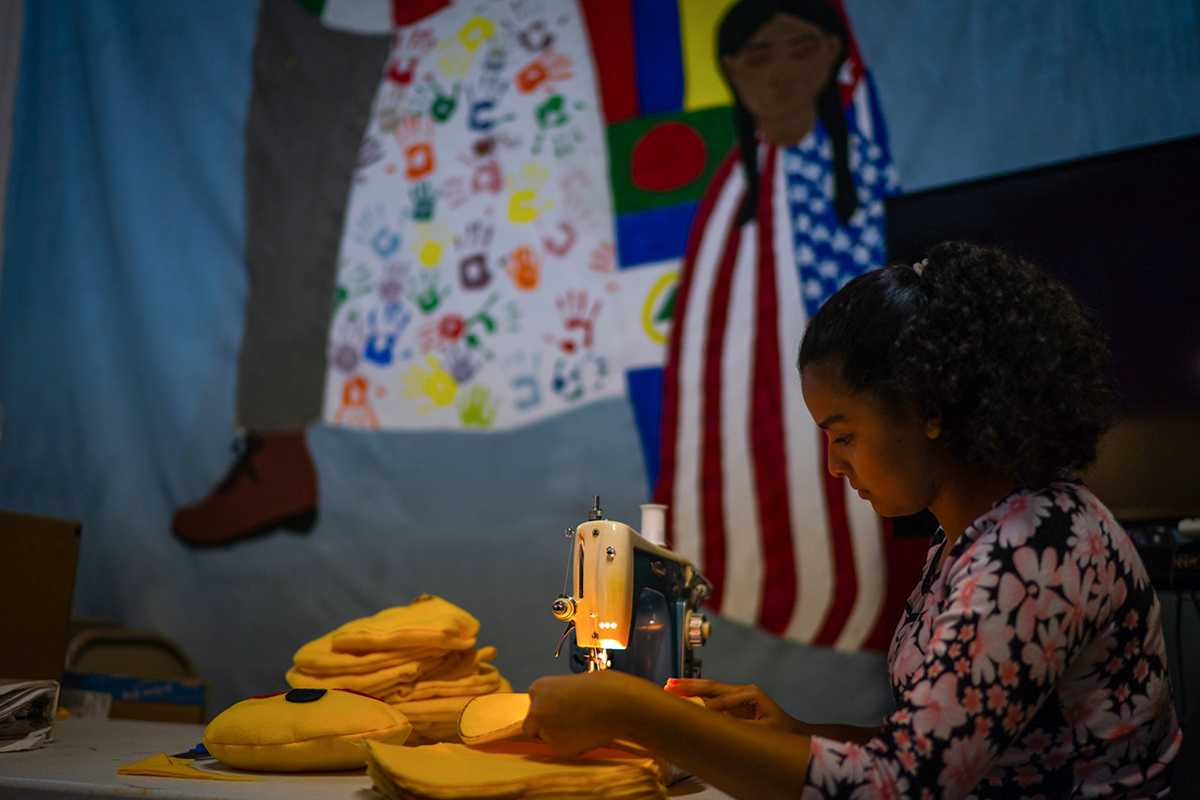 Wendy Garcia, 17, makes an "emoji" pillow, one of hundreds stacked in the Guatemalan-Maya Center for migrant children in south Florida. (Angel Mendoza/News21)