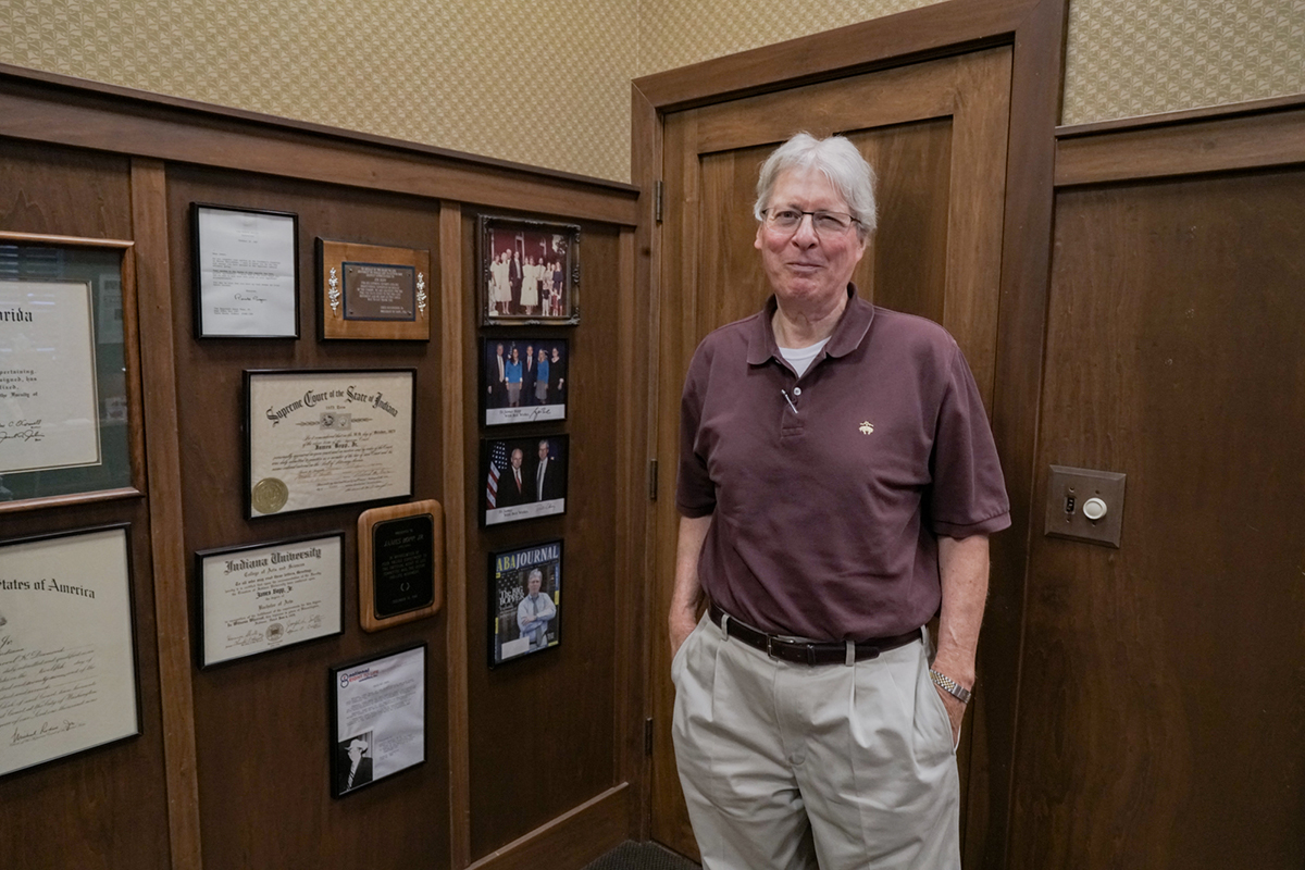 Attorney Jim Bopp stands in his office in Terre Haute, Indiana, near photos he had taken with former President George W. Bush and former Vice President Dick Cheney. Bopp, who practices constitutional law, is an opponent of hate crime legislation in Indiana and has testified in the statehouse against it. (Carley Lanich/News21)