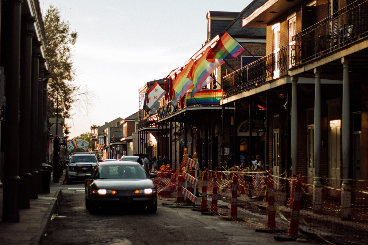 Multicolored LGBTQ flags fly from a balcony in the New Orleans French Quarter. In 2012, the Justice Department ordered reforms for the New Orleans Police Department, saying it was riddled with biased policing and "a lack of respect for the civil rights and dignity of the people of New Orleans." The department agreed to treat transgender individuals, in particular, with more respect.  (Megan Ross/News21)