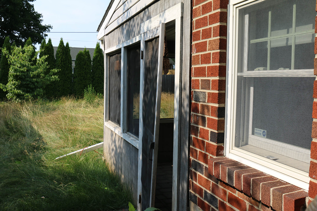 The now derelict porch of Robert Kujawa's home in Bethlehem Township, which is in foreclosure. Biafra Baker said her former neighbor would often pace back and forth on the porch, muttering racial slurs about the Bakers. (Connor Murphy/News21)